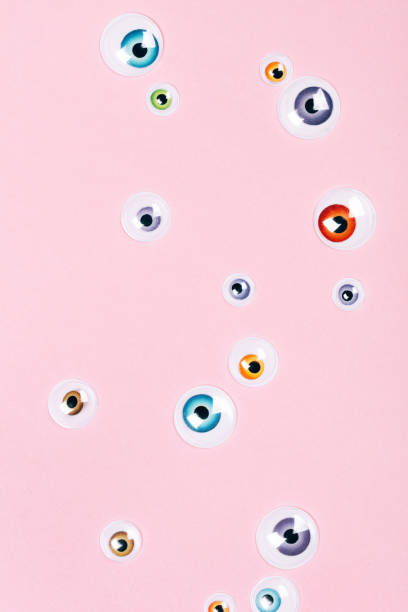 istock Many eyes on pink background 1058327636