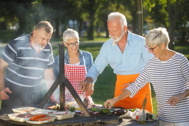 istock Senior people having a barbecue on a picnic day 1058335966
