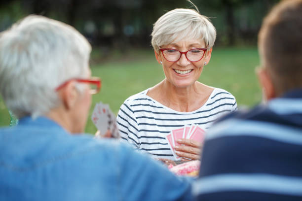 istock Senior people playing cards game 1058339744