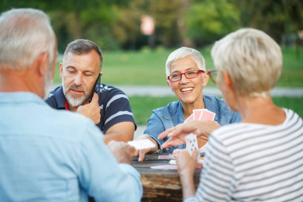 istock Senior people playing cards game 1058339768
