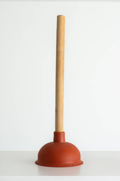 istock Red plunger with wooden grip against bright white background 1058342846