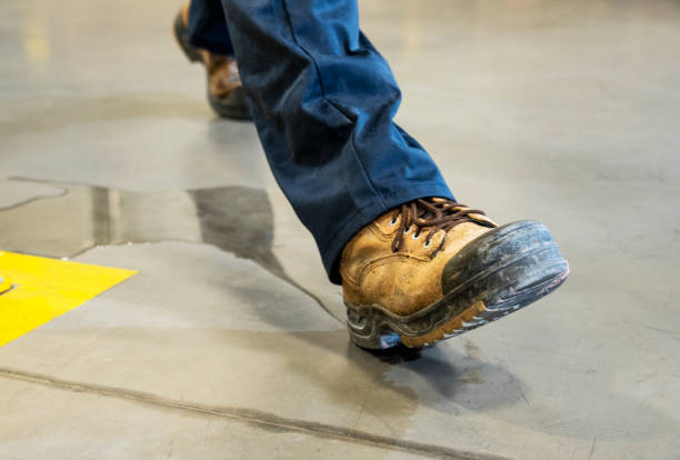 istock An industrial, manufacturing, safety topic.  A worker slipping on liquid. 1058343254