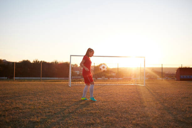 Royalty free image: female soccer player traps airborn ball.