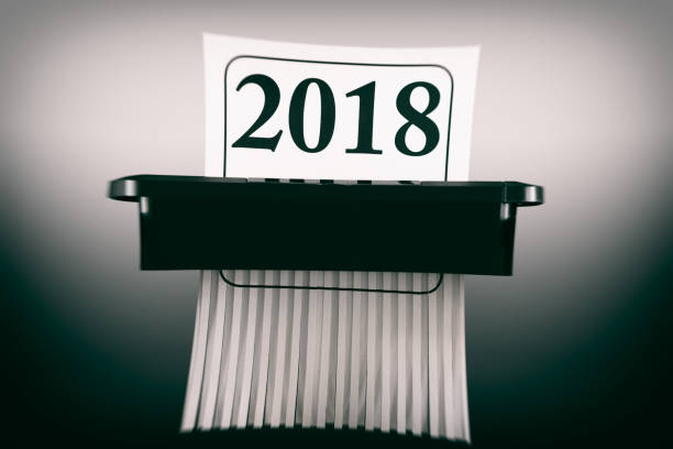 istock Destroying the Year 2018 in Paper Shredder 1058353954