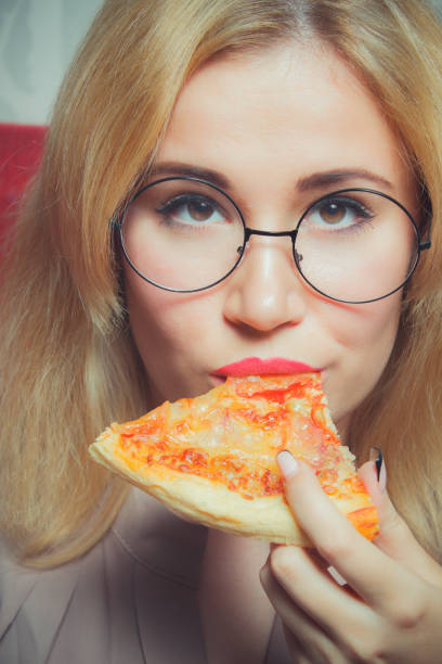 istock Smart girl eating pizza 1058354126