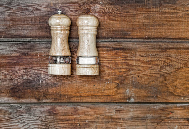 salt, pepper, shaker, wooden background, cooking, food, cafe, pu salt and pepper shakers on a wooden background. Concept: cooking, food, cafe, pub, restaurant. Spice. Top view rustic style spicery stock pictures, royalty-free photos & images