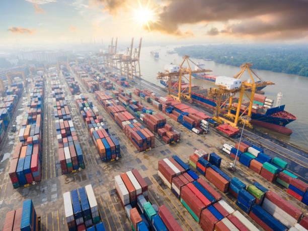 istock Container Cargo freight ship with working crane bridge in shipyard in singapore 1058362244