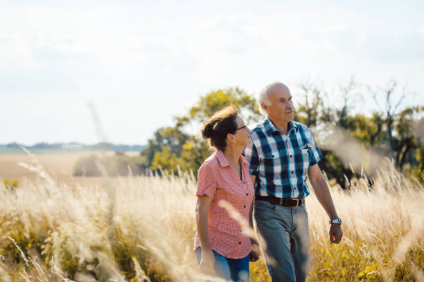 istock Senior couple walking down a path in nature 1058363442