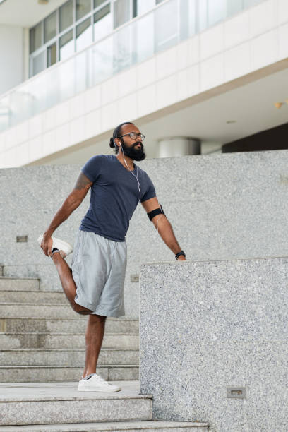 istock Male Runner Stretching Outdoors 1058364920