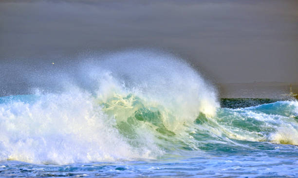 istock Splashing wave against a stormy sky. 1058365194