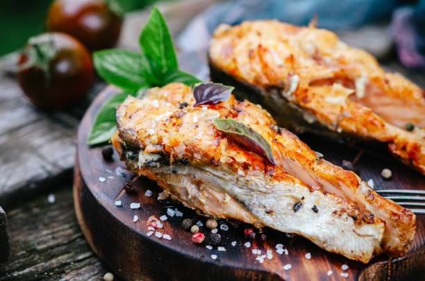 istock Grilled salmon on a wooden board on an old table 1058365594
