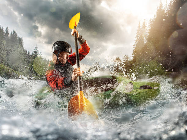 whitewater kayaking, extreme kayaking. a guy in a kayak sails on a mountain river - rafting imagens e fotografias de stock