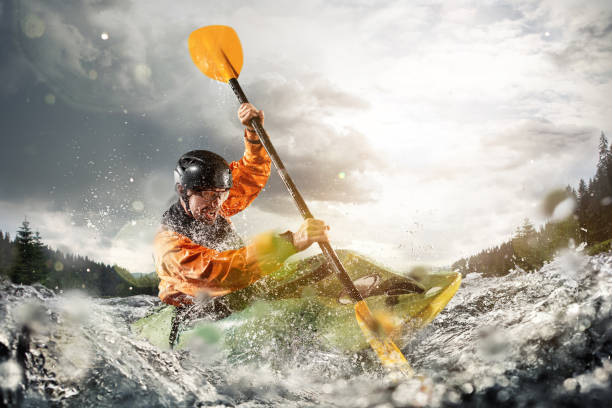 whitewater kayaking, extreme kayaking. a guy in a kayak sails on a mountain river - adrenaline imagens e fotografias de stock