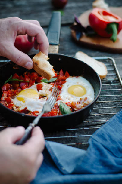 istock Shakshuka, Fried Eggs with Tomato Sauce in a Pan, Rustic Style and Wooden Background 1058365854
