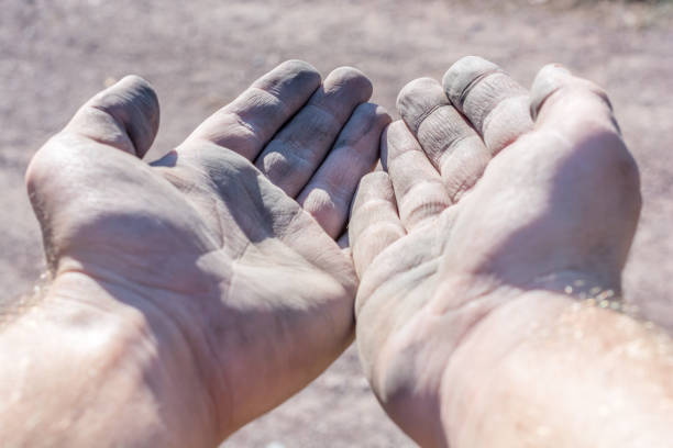 istock Dirty and wrinkled hands ask for donation 1058368292