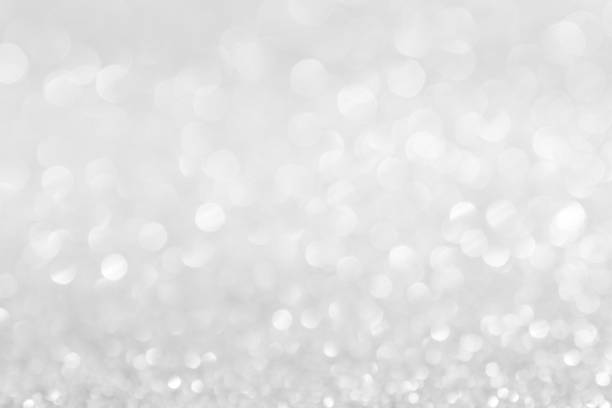 istock abstract background white Silver lights on christmas bokeh 1058368800