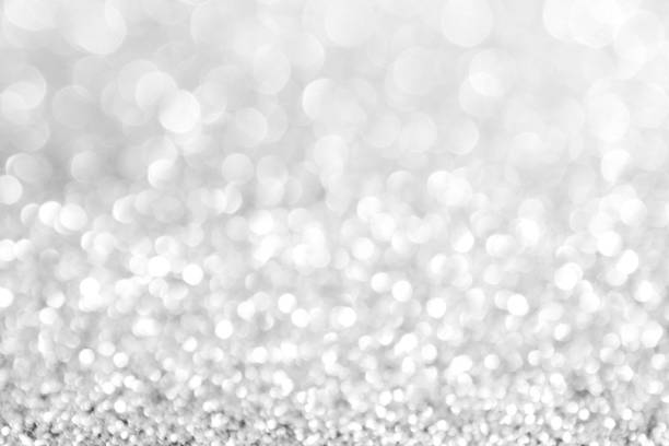 istock abstract background white Silver lights on christmas bokeh 1058368978