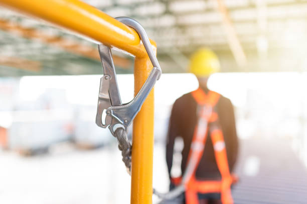 istock Industrial Worker with safety protective equipment loop hanging on the bar besides 1058369264