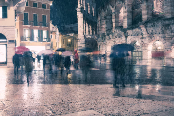 istock Old European illuminated city at rainy night 1058369392