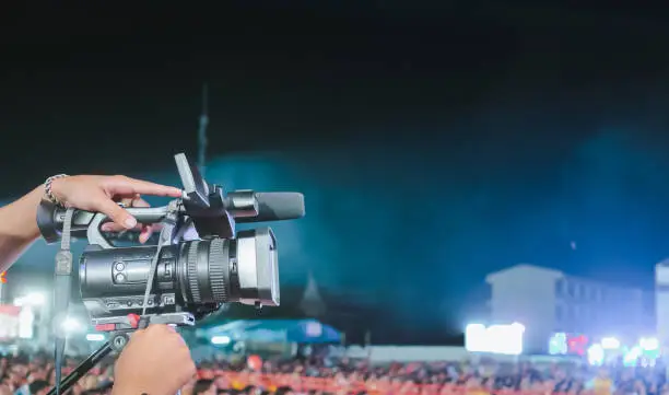 Photo of Professional digital camera recording video in music concert festival