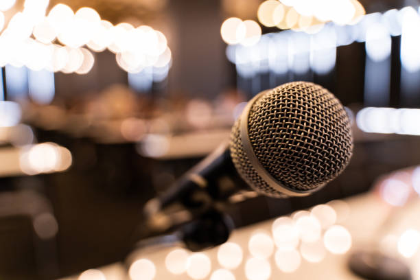 istock Microphone over the blurred business forum Meeting or Conference Training Learning Coaching Room Concept, Blurred background. 1058372756