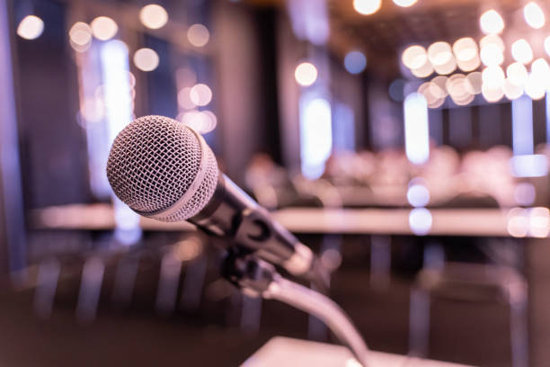 istock Microphone over the blurred business forum Meeting or Conference Training Learning Coaching Room Concept, Blurred background. 1058372768