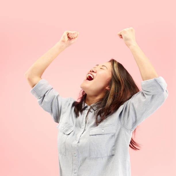 istock Winning success woman happy ecstatic celebrating being a winner. Dynamic energetic image of female model 1058372804