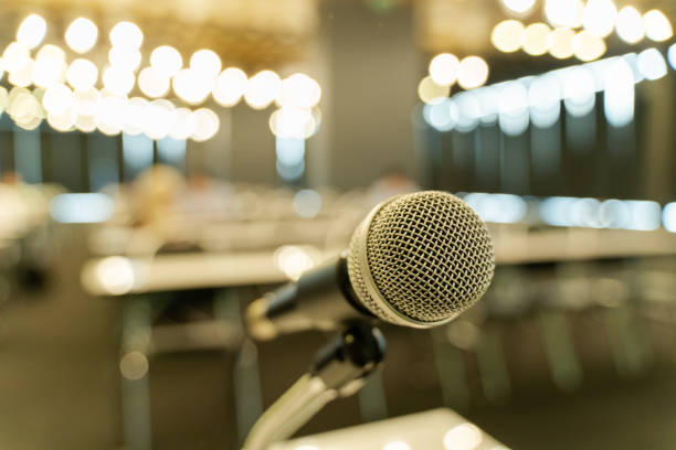 istock Microphone over the blurred business forum Meeting or Conference Training Learning Coaching Room Concept, Blurred background. 1058372912