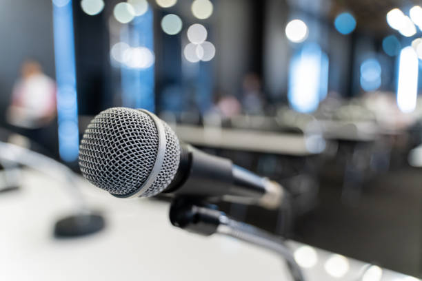 istock Microphone over the blurred business forum Meeting or Conference Training Learning Coaching Room Concept, Blurred background. 1058372928