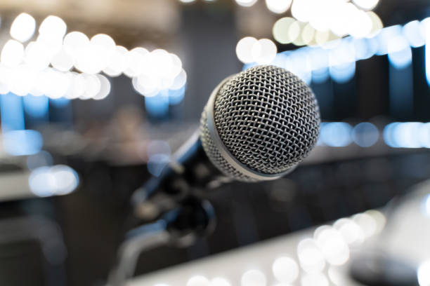 istock Microphone over the blurred business forum Meeting or Conference Training Learning Coaching Room Concept, Blurred background. 1058373014