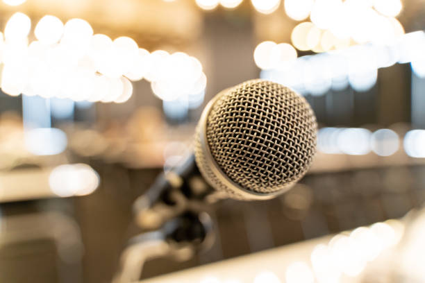 istock Microphone over the blurred business forum Meeting or Conference Training Learning Coaching Room Concept, Blurred background. 1058373044