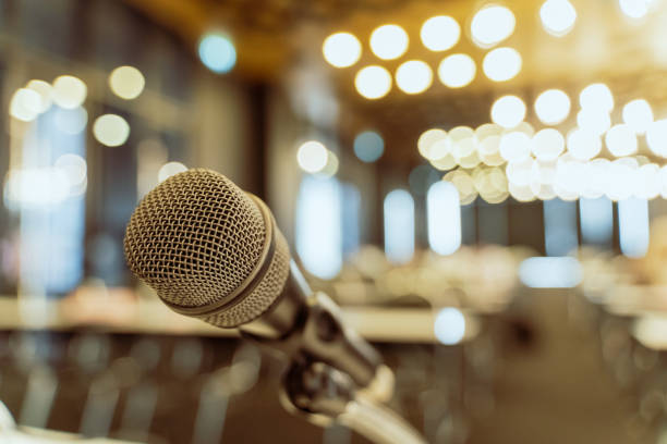 istock Microphone over the blurred business forum Meeting or Conference Training Learning Coaching Room Concept, Blurred background. 1058373102