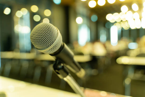 istock Microphone over the blurred business forum Meeting or Conference Training Learning Coaching Room Concept, Blurred background. 1058373146