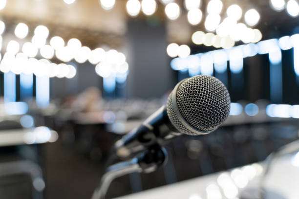 istock Microphone over the blurred business forum Meeting or Conference Training Learning Coaching Room Concept, Blurred background. 1058373148