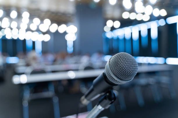istock Microphone over the blurred business forum Meeting or Conference Training Learning Coaching Room Concept, Blurred background. 1058373170