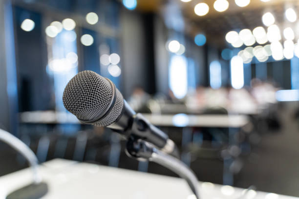 istock Microphone over the blurred business forum Meeting or Conference Training Learning Coaching Room Concept, Blurred background. 1058373204