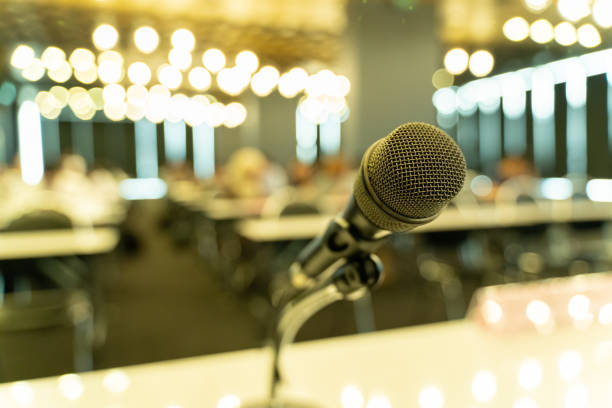 istock Microphone over the blurred business forum Meeting or Conference Training Learning Coaching Room Concept, Blurred background. 1058373228