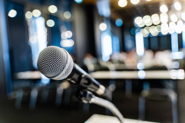 istock Microphone over the blurred business forum Meeting or Conference Training Learning Coaching Room Concept, Blurred background. 1058373310