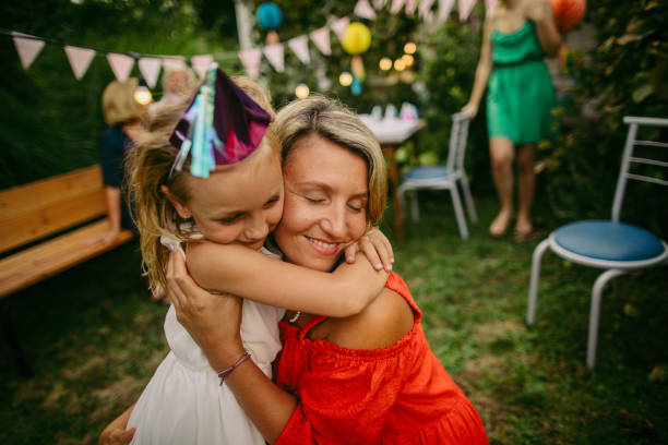 Birthday girl hugging with her mother
