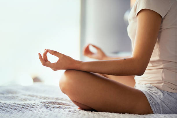 In the zen zone Cropped shot of a woman meditating at home meditation hands stock pictures, royalty-free photos & images