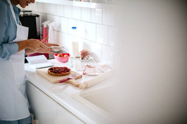 Woman makes a cake in the kitchen