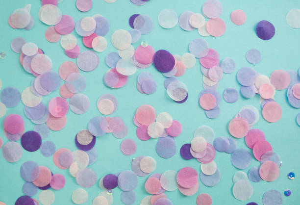 istock Multicolored confetti and sparkles on blue background. 1058390274
