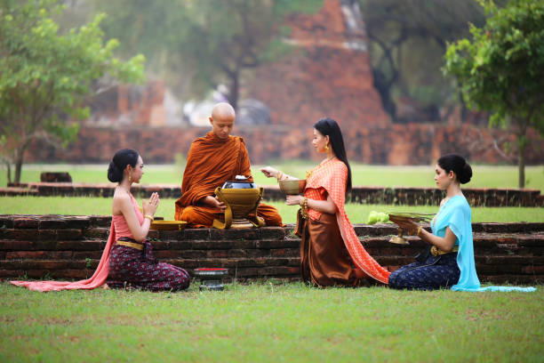 istock Women Performing Religious Activity With Monk 1058395542