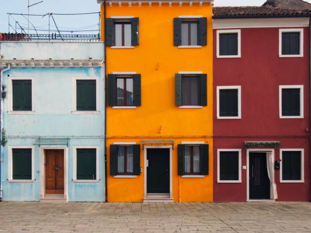istock three colourful brightly painted typical houses in Murano Venice Italy 1058397802