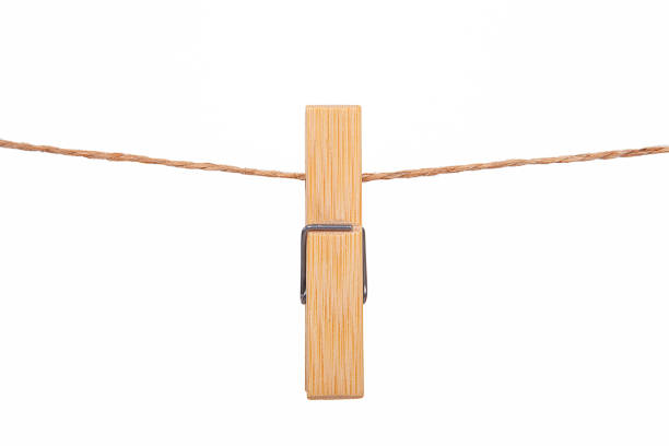 istock Wooden clothes pegs isolated on a white background. 1058401092