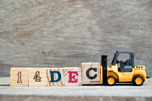 istock Toy forklift hold block c to complete word 14dec on wood background (Concept for calendar date 14 in month December) 1058408216