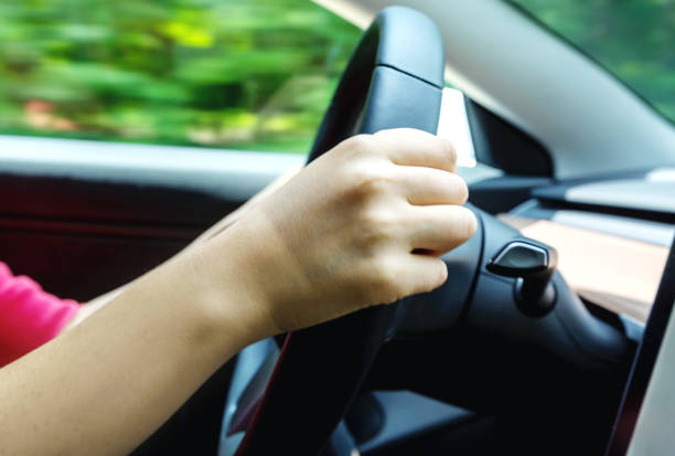 istock Person driving a luxury vehicle down the road 1058408708
