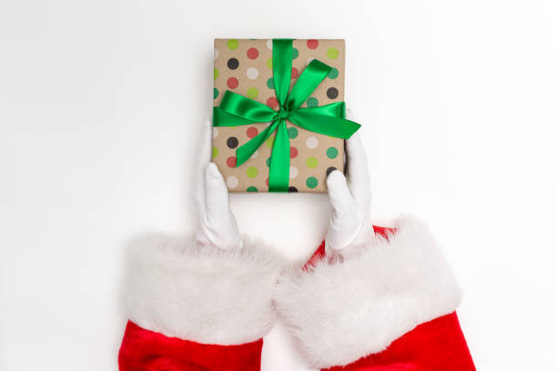 istock Santa holding a Christmas gift 1058408918