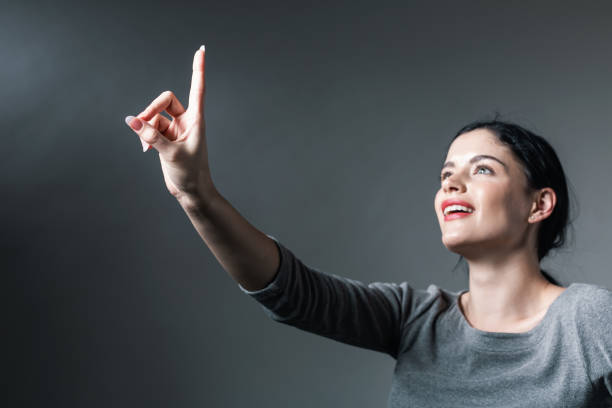 istock Young woman pointing at something 1058409592