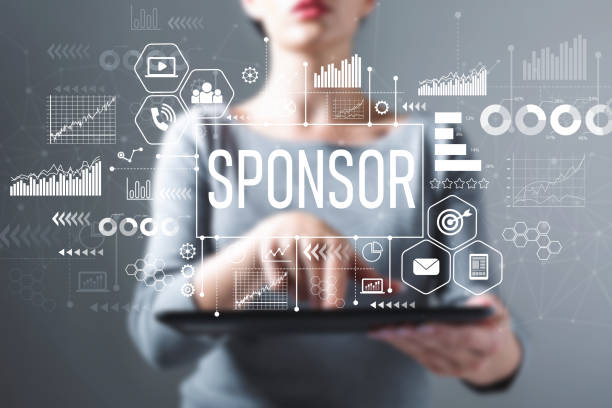 Sponsor with woman using a tablet stock photo